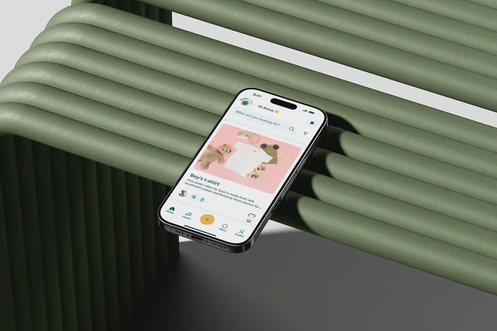 An iPhone resting on a green tubular structure displaying the YoungPlanet app homepage with a featured listing