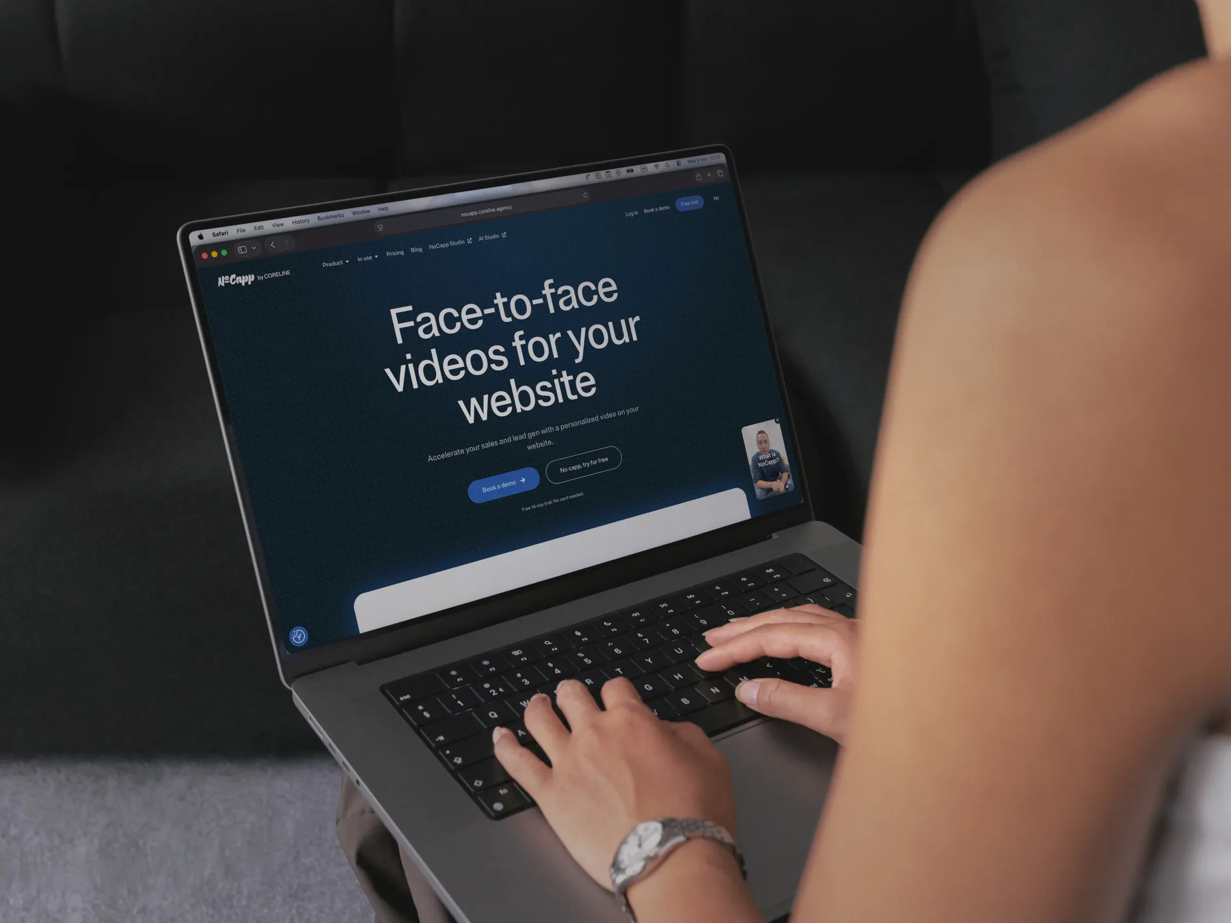 Person typing on a laptop displaying a website promoting face-to-face videos for websites.